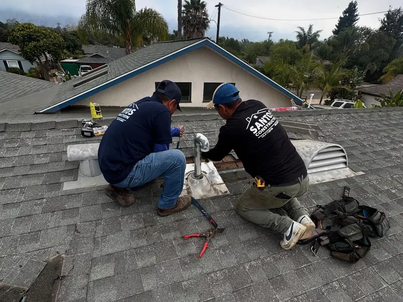 Santos crew installing a roof vent on a shingle roof